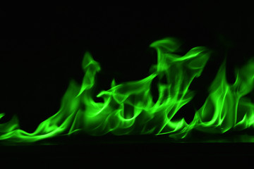 Beautiful fire green flames on a black background.