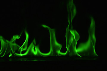 Beautiful fire green flames on a black background.