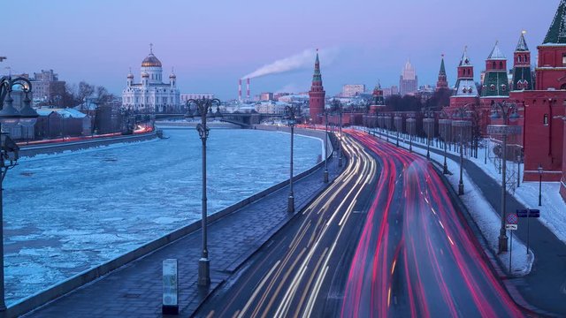Time Lapse of a Moscow traffic at morning near the frozen  moscova river in winter. Include the Kremlin towers and Christ the Savier Cathedral church at background