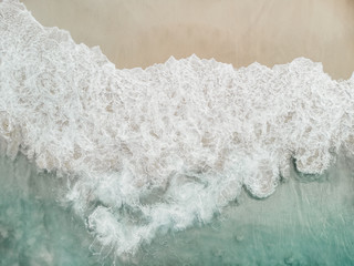 Top view of beautiful white aerial drone shot, sand sea water and palm trees, beach with turquoise