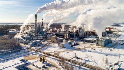Pulp and Paper Mill. Finland plant in the winter. Smoke and smog