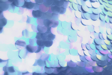 Abstract background sequins, sequins laid out in rows. Soft focus.