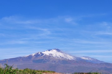 Fototapeta premium Etna volcano covered in snow. View from afar. Sicily