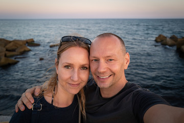 Fototapeta na wymiar A couple at the Barcelona Beach at sunset