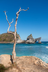 Atuh Beach With Famouse Rock Island Outcrop and Natural Arch Carved By The Bright Turquoise Ocean on Nusa Penida, Bali, Indonesia