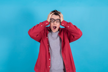 young man or teenage student isolated on color background with expression of amazement or surprise