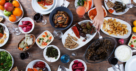 dinner table with many hands