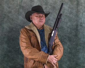 Fototapeta premium studio portrait of a cowboy with shotgun