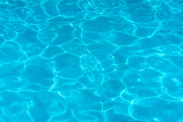 Naklejka na ściany i meble Water surface with light reflections in a swimming pool as a background