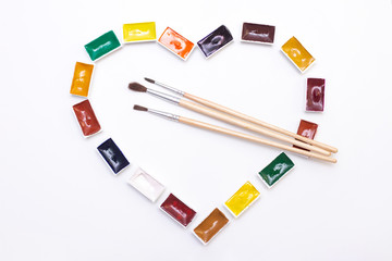 Heart shaped watercolor art paint. with brushes. palette of multi-colored paints for drawing with...