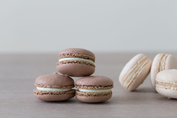 Food. macaroons brown and white, beige background
