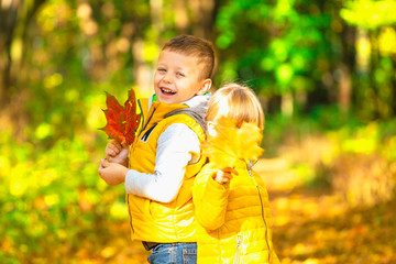 Portrait of two happy children an autumn park