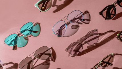 Variety of sunglasses over colorful background