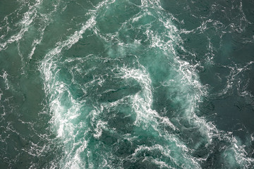 Fototapeta na wymiar A Cruise ship wake with green seas on the Pacific Ocean.