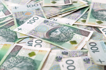 Obraz na płótnie Canvas Polish zloty banknotes background. 100 Polish zloty bills pile. Republic of Poland currency