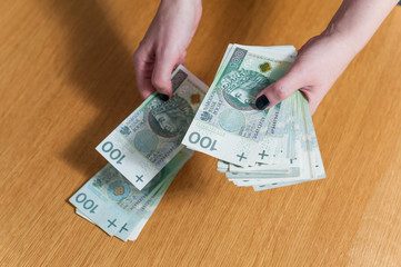 Woman hands counting Polish money cash
