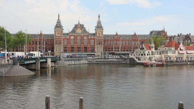 Central Train Station Building and Water Canal in Amsterdam
