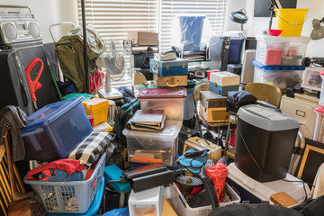 Hoarder room packed with boxes, electronics, business equipment, household objects and...