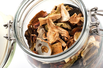 Close-up of dried homemade mushrooms in vintage glass jar.