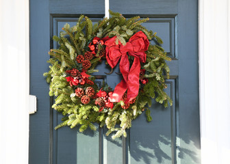 a Christmas wreath on the door to an office building