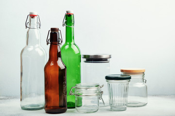 Reusable glass bottles and jars on table. Sustainable lifestyle. Zero waste grocery shopping and storage concept
