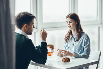 young couple having breakfast in the kitchen