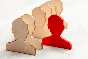 Staff recruitment. The figures of the workers are all the same and one in red. Leader Choice. HR....
