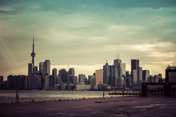 A high-contrast view of the Toronto skyline with a dramatic sky covered in clouds, Toronto, Ontario, Canada