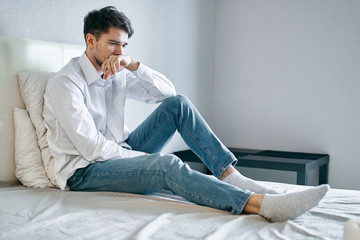 man sitting on sofa and looking at camera