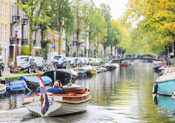 A private boat tour goes down a canal in the Jordaan neighborhood of Amsterdam. 