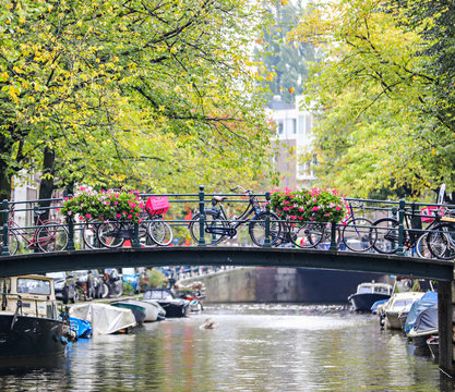 Looking at a row of bikes along a bridge in the Jordaan neighborhood of Amsterdam, from the canal. 