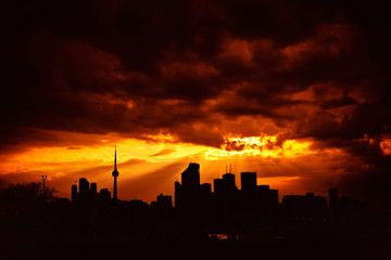 Fototapeta na wymiar A high-contrast view of the Toronto skyline with a dramatic sky covered in clouds, Toronto, Ontario, Canada