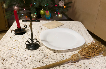 Pastoral visit articles on a table: cross, holy water, sprinkler and envelope with donation....