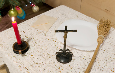 Pastoral visit articles on a table: cross, holy water, sprinkler and envelope with donation. Tradition of catholic church in Poland called koleda