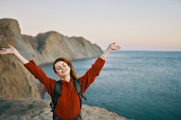 happy woman with arms outstretched on beach