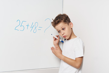 little girl writing on blackboard