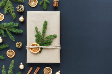 Zero waste christmas concept - christmas present wrapped in craft paper and natural decorations around. Top view xmas photo