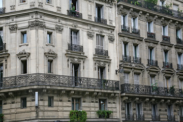 Fototapeta na wymiar Paris, typical old apartment building with wrought iron balcony railings and planters.