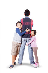 Man doing back pose while his children hugging him