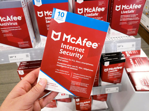 A hand holding McAfee Internet Security box