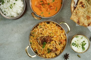 Indian meal menu - Goat Biryani Butter chicken Naan background