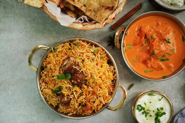 Indian meal menu - Goat Biryani Butter chicken Naan background