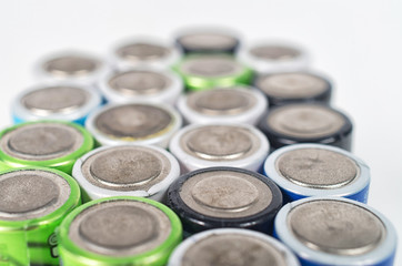 Close up top view on rows of selection of Ni-MH AA batteries negative side. Several batteries are...