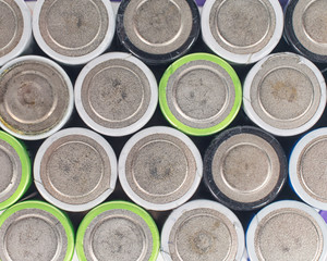 Close up top view on rows of selection of Ni-MH AA batteries negative side. Several batteries are next to each other.