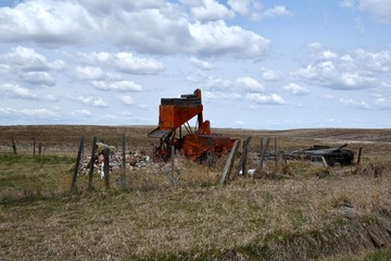 rusty farm equipment in a field