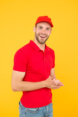 Postman delivery worker. Man red cap yellow background. Delivering purchase. Already ready. Easing your business. Service delivery. Salesman and courier career. Courier and delivery service