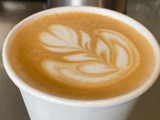 cup of coffee with cream on white background