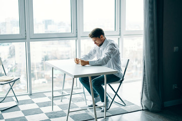 man sitting on chair in front of window