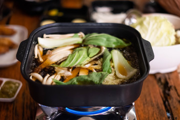 Shabu or suki yaki in the hot pot, sliced meat and vegetables boiled in soup.