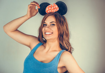 woman wearing black mouse ears playing flirty